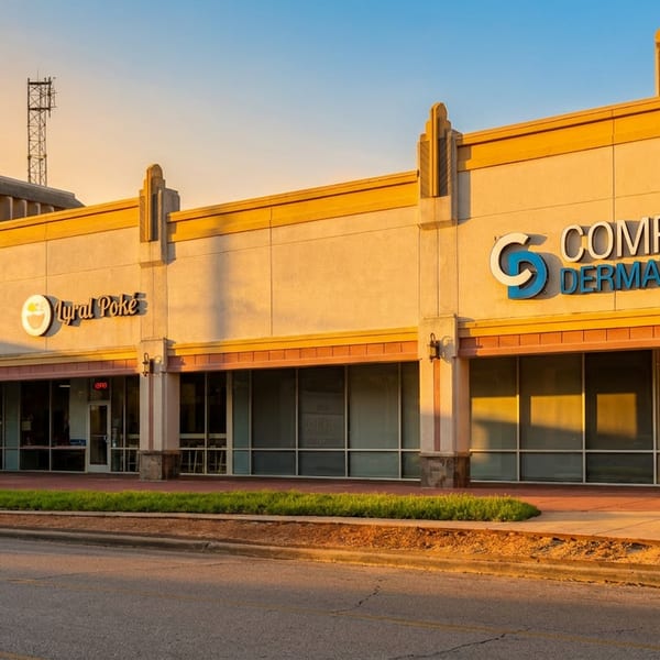 Exterior of a strip mall with businesses like Myral Poke, Memorial Hermann Urgent Care, and Complete Dermatology.
