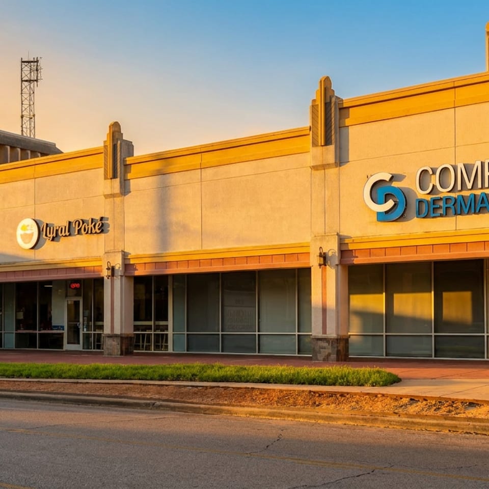 Exterior of a strip mall with businesses like Myral Poke, Memorial Hermann Urgent Care, and Complete Dermatology.